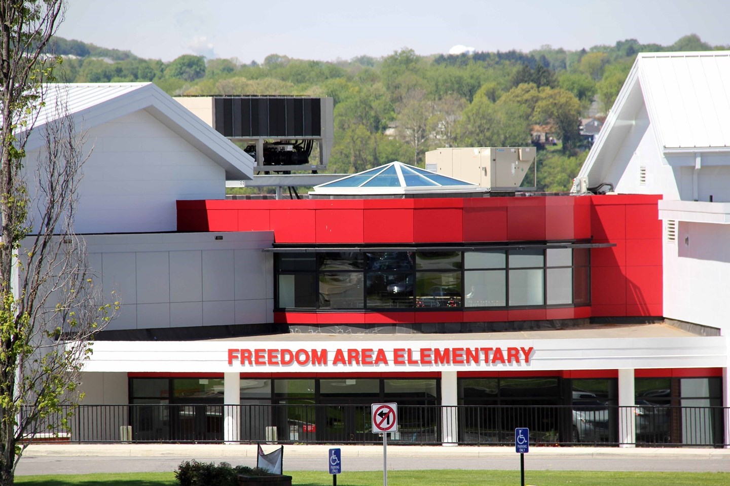 Freedom Area Elementary  red and white building with green trees behind the building 