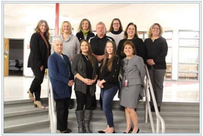 Board Members 2022 standing on steps in the Middle School